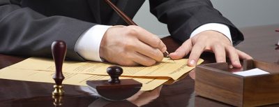 Businessman writing testament at notary public office
